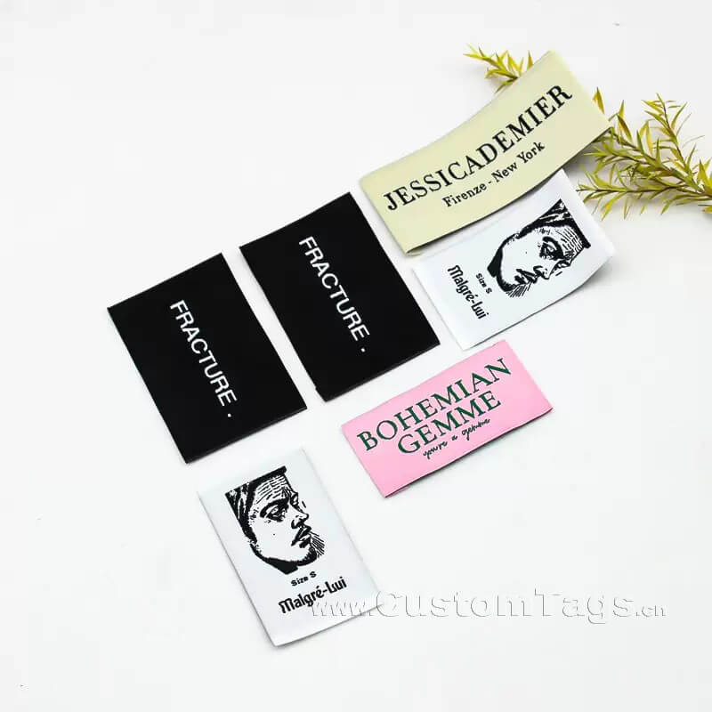 High density custom damask woven label showing detailed brand logo for fashion clothing.