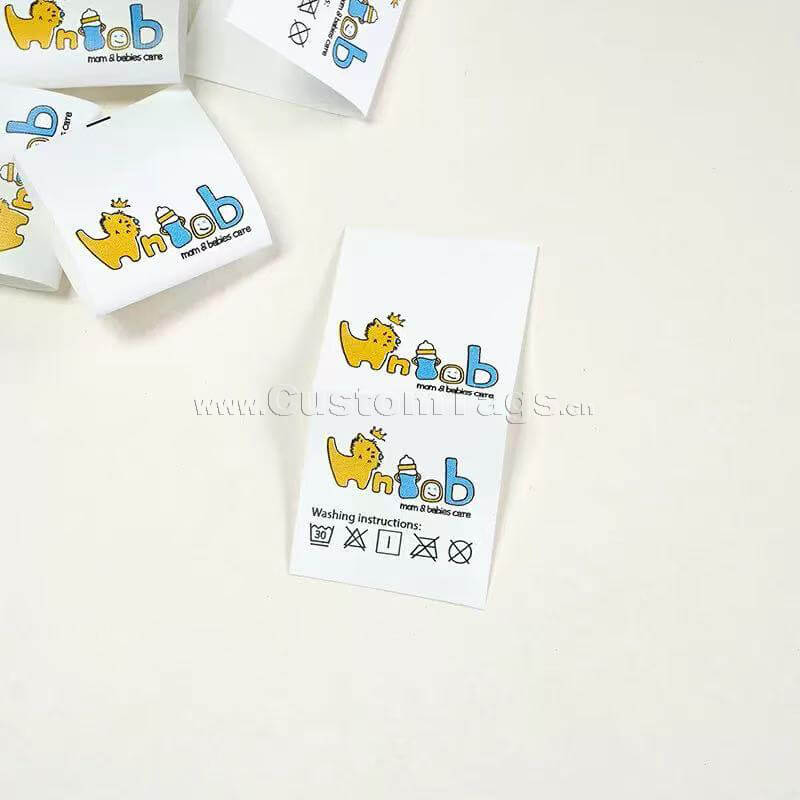Custom printed satin wash care labels with laundry instructions for clothing brands