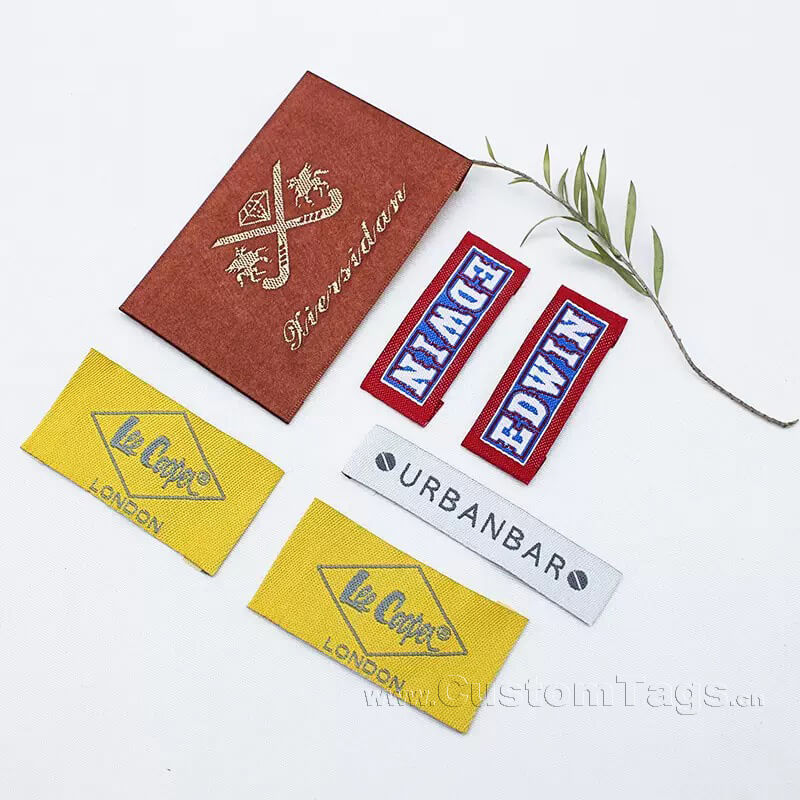 High density custom damask woven label showing detailed brand logo for fashion clothing.