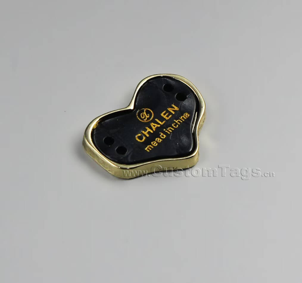 Customized enameled metal clothing label with durable color-filled logo